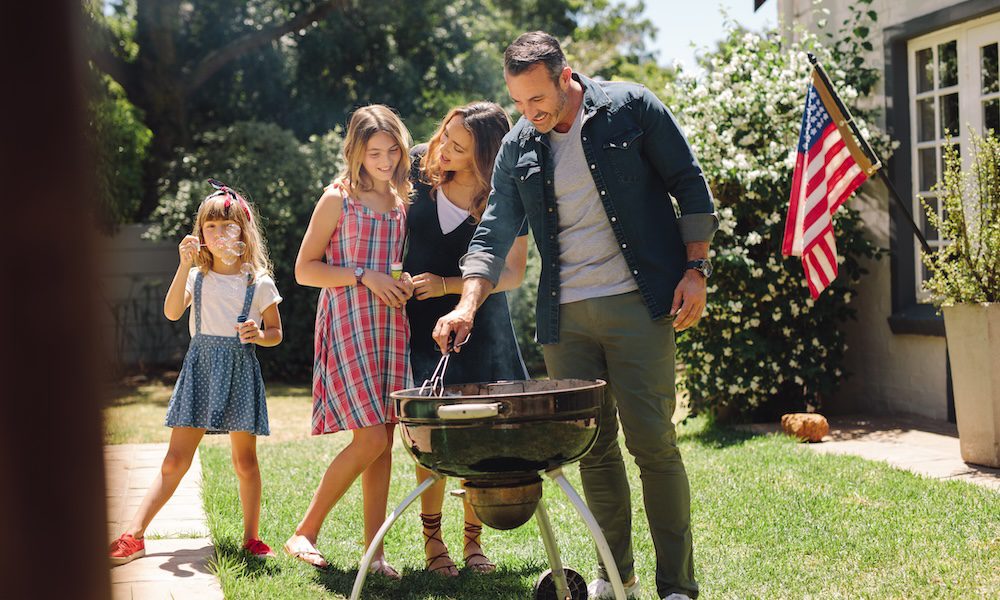 Sizzling Safety/ Your Guide to Grilling with Confidence - A Family of 4 having a bbq in the back yard with Dad manning the grill